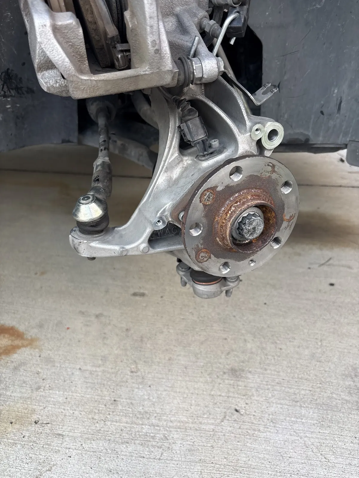 Wheel hub and brake assembly mid-repair in a customer's driveway